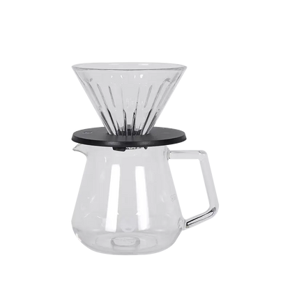 Cafetera pour-over de vidrio transparente con base negra y jarra con asa Timemore