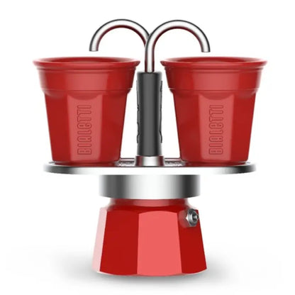 Cafetera moka Mini Express Bialetti roja con 2 vasos rojos y base roja brillante