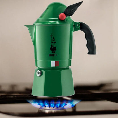 Cafetera moka Bialetti Alpina verde con asa negra y botón rojo sobre base.