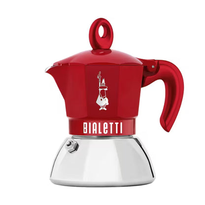Cafetera moka de Bialetti roja con jarra y asa lateral, base metálica blanca.