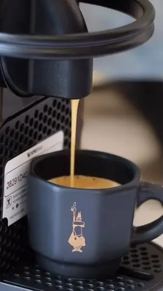 Máquina de café en uso, preparando café con cápsulas para Nespresso.